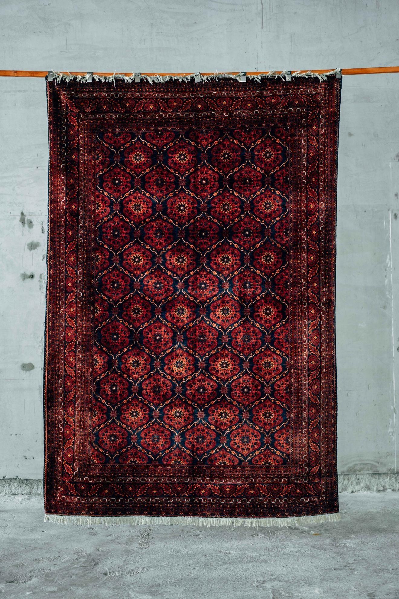 a traditional rug hanging on a wire 
